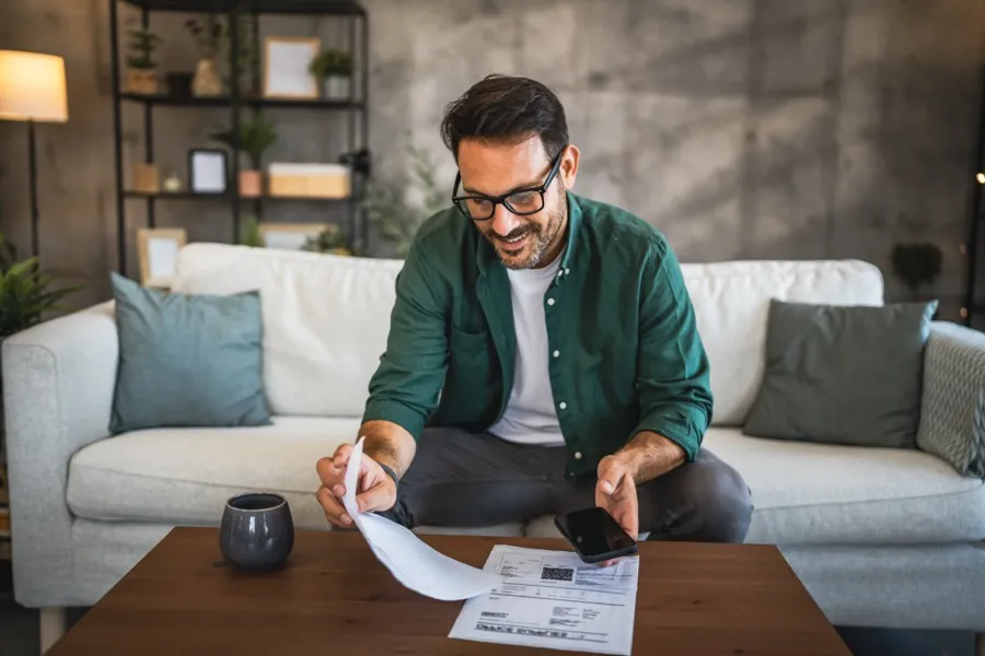 A patient at home reading a printed treatment estimate